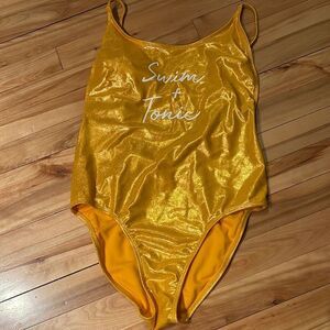 No boundaries gold foil sparkle one piece graphic swim suit. NWOT. medium (7-9)